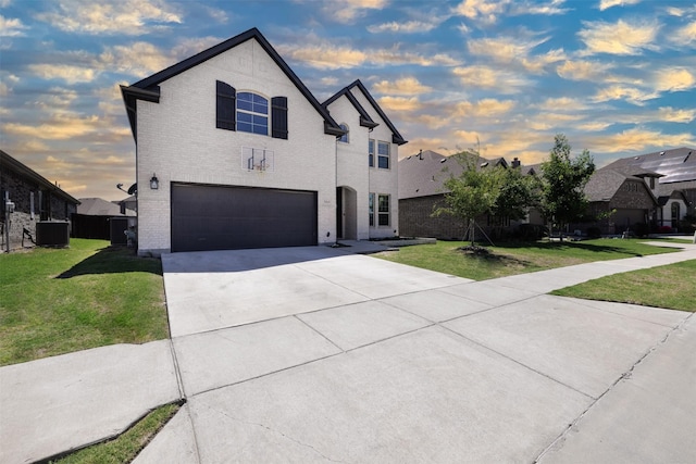 664 Fletcher Dr, Fate, TX 75087 - french provincial home featuring a garage, driveway, central air condition unit, and brick siding