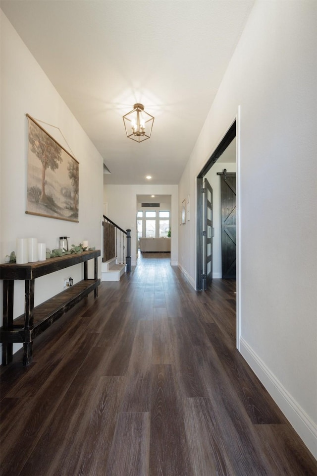 664 Fletcher Dr, Fate, TX 75087 - corridor with dark wood finished floors, baseboards, and stairs