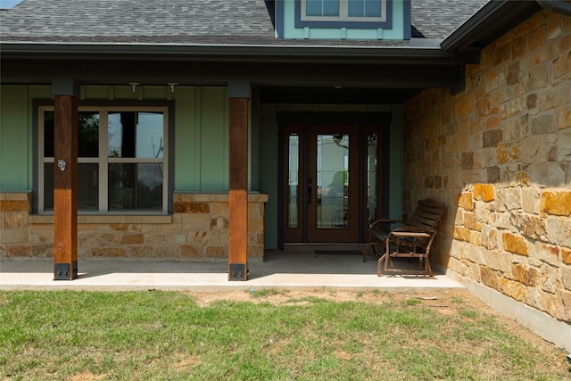 14447 Warbler Ln, Haslet, TX 76052 - view of exterior entry featuring a shingled roof, stone siding, board and batten siding, and covered porch