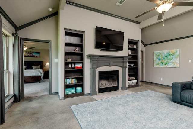 14447 Warbler Ln, Haslet, TX 76052 - living room with a ceiling fan, vaulted ceiling, a tiled fireplace, built in shelves, and carpet flooring
