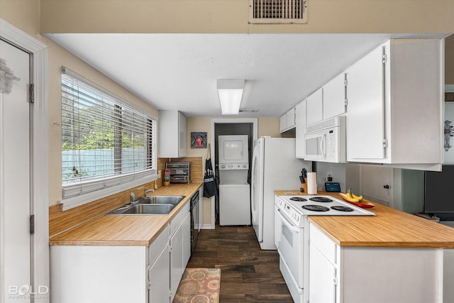 216 Settlers Park Dr, Shreveport, LA 71115 - kitchen with white appliances, stacked washing machine and dryer, a sink, light countertops, and dark wood finished floors