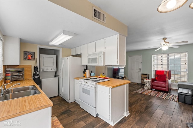 216 Settlers Park Dr, Shreveport, LA 71115 - kitchen featuring white appliances, stacked washer / dryer, a sink, dark wood finished floors, and white cabinetry