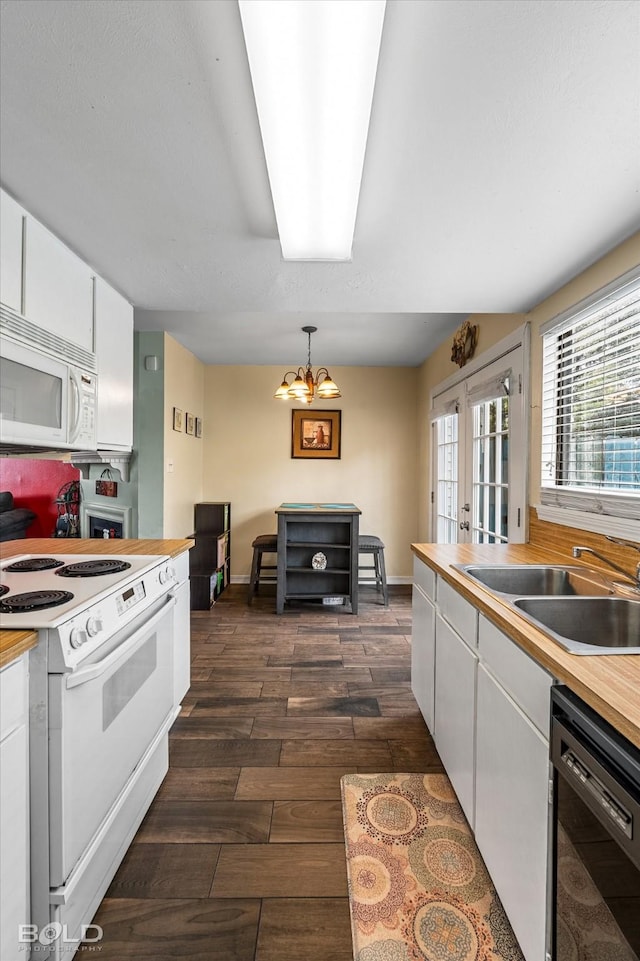 216 Settlers Park Dr, Shreveport, LA 71115 - kitchen featuring white appliances, a sink, white cabinetry, and dark wood-type flooring