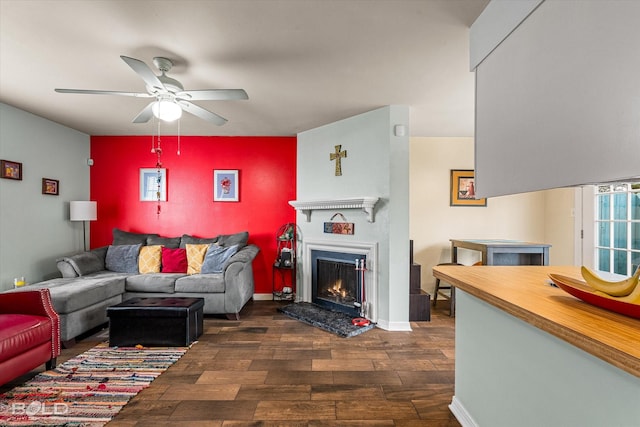 216 Settlers Park Dr, Shreveport, LA 71115 - living area featuring dark wood finished floors, ceiling fan, a lit fireplace, and healthy amount of natural light