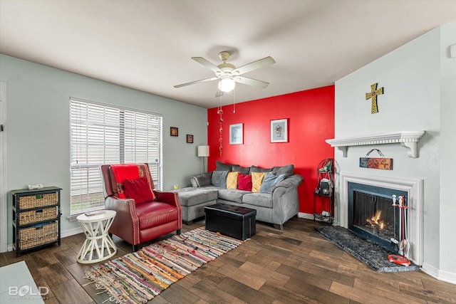 216 Settlers Park Dr, Shreveport, LA 71115 - living area featuring wood finished floors, ceiling fan, a warm lit fireplace, and baseboards