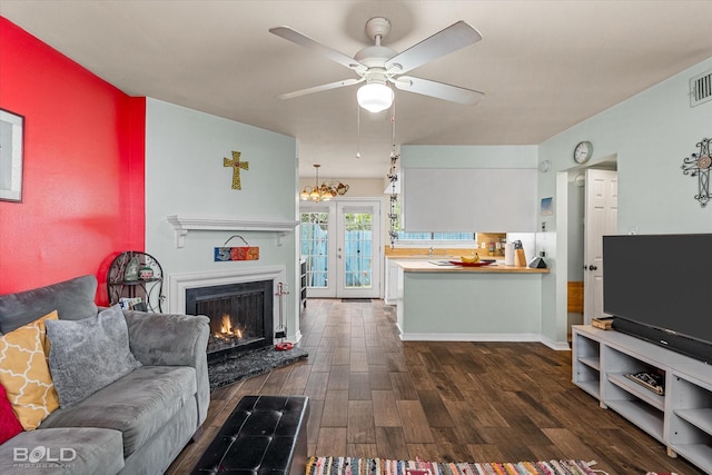 216 Settlers Park Dr, Shreveport, LA 71115 - living room with dark wood-style floors, a ceiling fan, and a lit fireplace