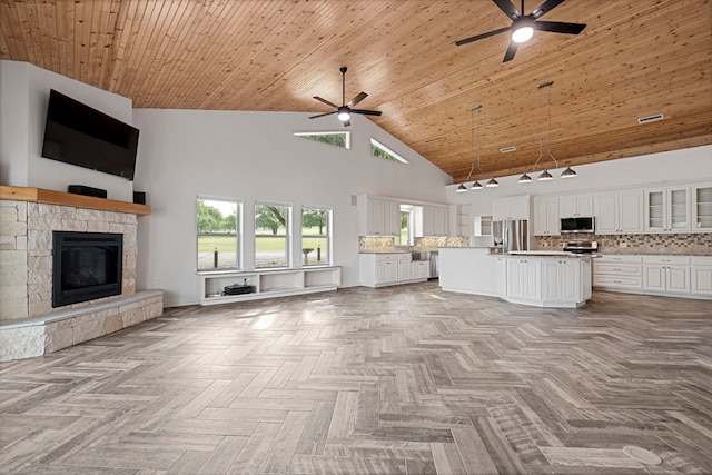 344 Clear Lake Ln, Weatherford, TX 76087 - unfurnished living room with ceiling fan, high vaulted ceiling, a stone fireplace, and wooden ceiling