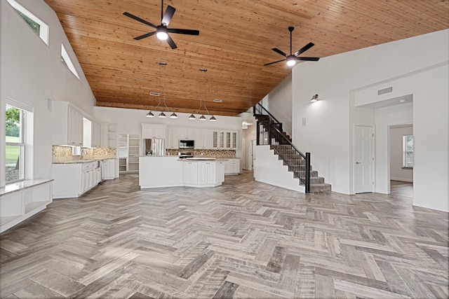 344 Clear Lake Ln, Weatherford, TX 76087 - unfurnished living room featuring a ceiling fan, high vaulted ceiling, a sink, stairway, and wooden ceiling
