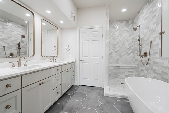 344 Clear Lake Ln, Weatherford, TX 76087 - full bathroom featuring a freestanding bath, tiled shower, double vanity, tile patterned flooring, and recessed lighting