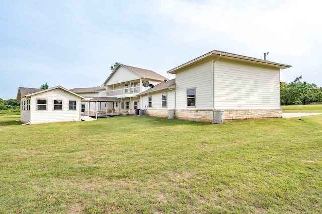 344 Clear Lake Ln, Weatherford, TX 76087 - rear view of house with a yard, central AC, and stone siding