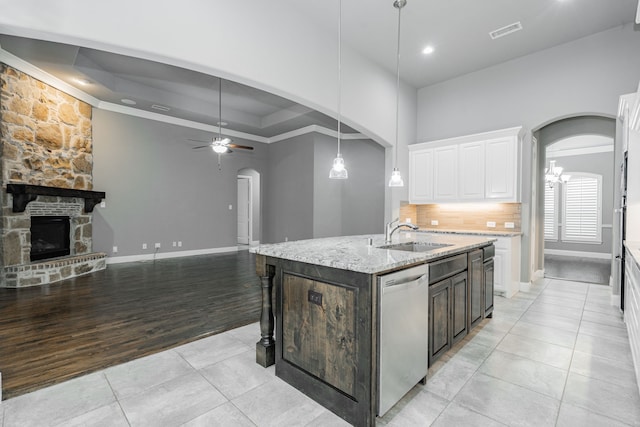 913 Colby Bluff Dr, Rockwall, TX 75087 - kitchen featuring a sink, arched walkways, dishwasher, ornamental molding, and light tile patterned floors