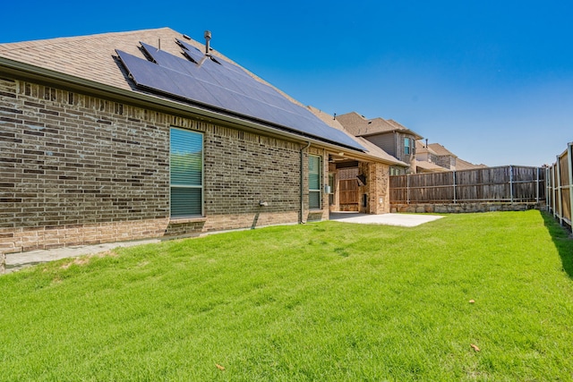 913 Colby Bluff Dr, Rockwall, TX 75087 - rear view of property featuring brick siding, solar panels, and a patio area