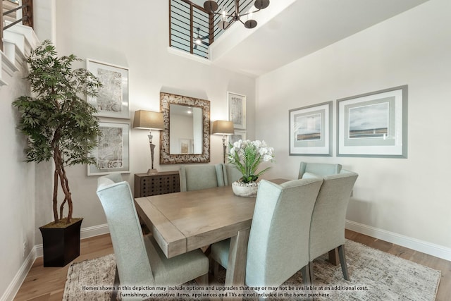12605 Rocky Top Rd, Godley, TX 76044 - dining space with a high ceiling, wood finished floors, a chandelier, and baseboards