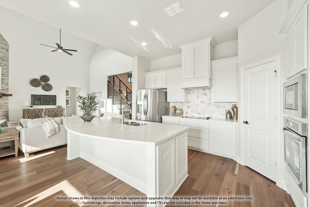 12605 Rocky Top Rd, Godley, TX 76044 - kitchen with stainless steel appliances, a sink, open floor plan, backsplash, and white cabinetry