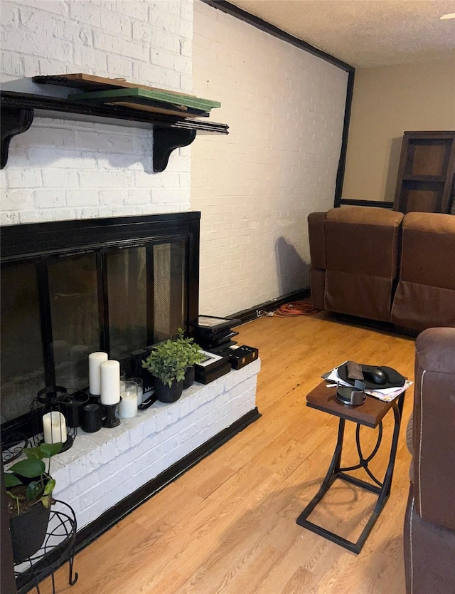 4138 Towngate Blvd, Garland, TX 75041 - living room featuring light wood-type flooring and a textured ceiling
