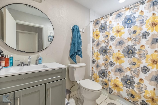 601 Westmoreland St, Abilene, TX 79603 - bathroom with vanity, toilet, a shower with shower curtain, and tile patterned floors