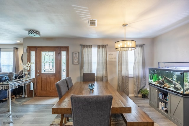 601 Westmoreland St, Abilene, TX 79603 - dining space featuring a chandelier, light wood-type flooring, and healthy amount of natural light
