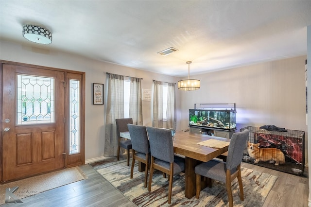 601 Westmoreland St, Abilene, TX 79603 - dining room featuring a chandelier, light wood-style floors, and baseboards