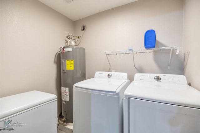 601 Westmoreland St, Abilene, TX 79603 - laundry area featuring electric water heater and washing machine and dryer