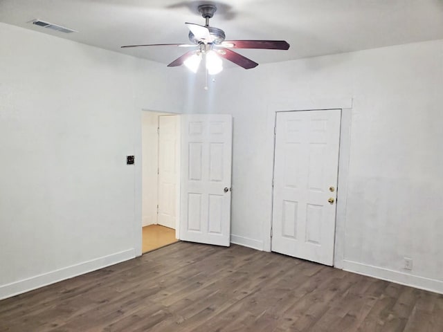 421 Jackson St, Krum, TX 76249 - unfurnished bedroom with wood finished floors, baseboards, and ceiling fan