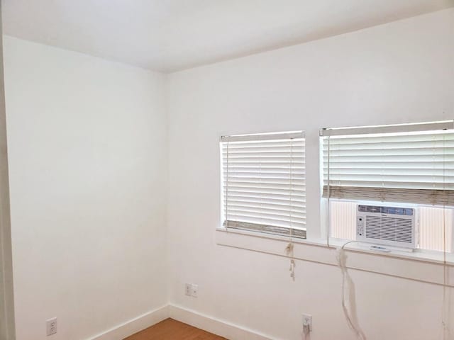 421 Jackson St, Krum, TX 76249 - empty room with baseboards, light wood-style floors, and cooling unit