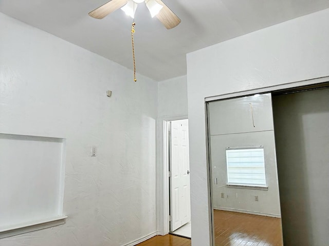 421 Jackson St, Krum, TX 76249 - unfurnished bedroom featuring wood finished floors, a ceiling fan, and a closet