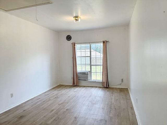 421 Jackson St, Krum, TX 76249 - spare room featuring attic access, wood finished floors, cooling unit, and baseboards