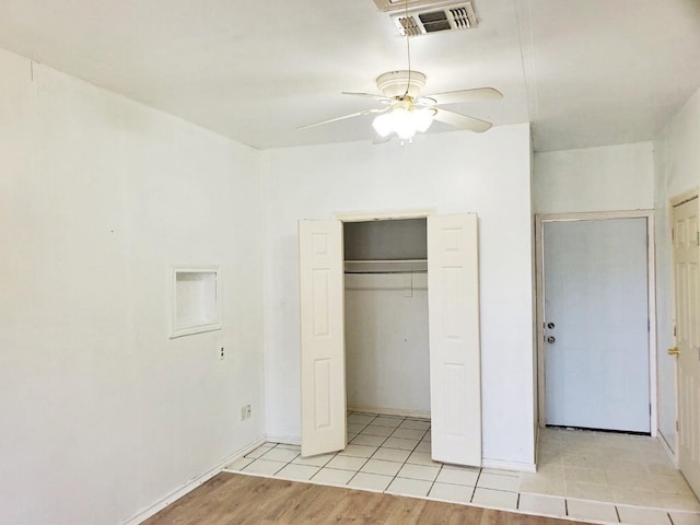 421 Jackson St, Krum, TX 76249 - unfurnished bedroom featuring light wood-style flooring, a closet, a ceiling fan, and baseboards