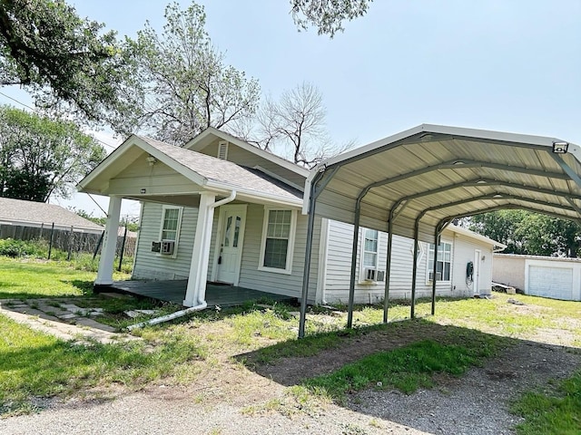 421 Jackson St, Krum, TX 76249 - view of front of house featuring dirt driveway, a carport, cooling unit, and a porch