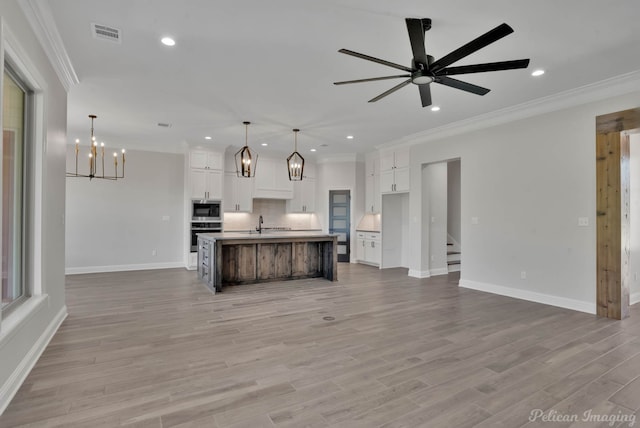 507 Cocodrie Dr, Bossier City, LA 71112 - kitchen with a chandelier, open floor plan, recessed lighting, crown molding, and white cabinets
