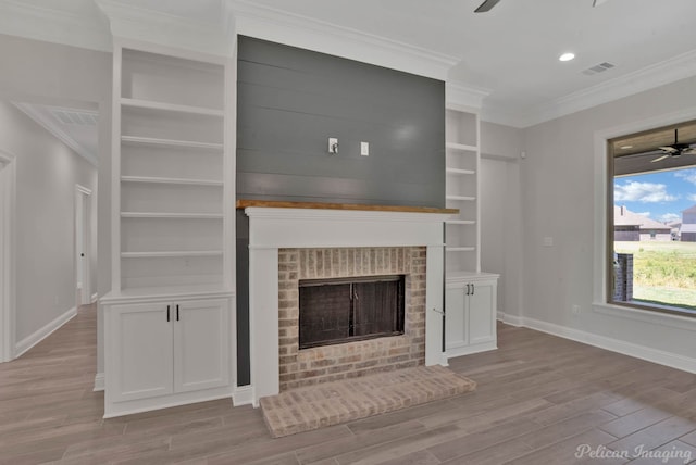 507 Cocodrie Dr, Bossier City, LA 71112 - unfurnished living room featuring ceiling fan, wood finished floors, baseboards, ornamental molding, and built in features