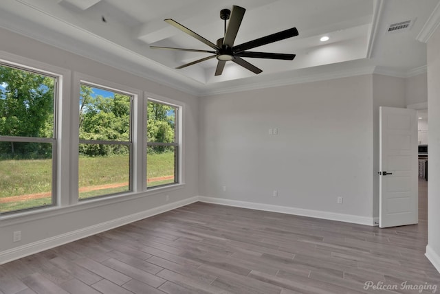507 Cocodrie Dr, Bossier City, LA 71112 - unfurnished room featuring baseboards, ceiling fan, wood finished floors, a raised ceiling, and crown molding