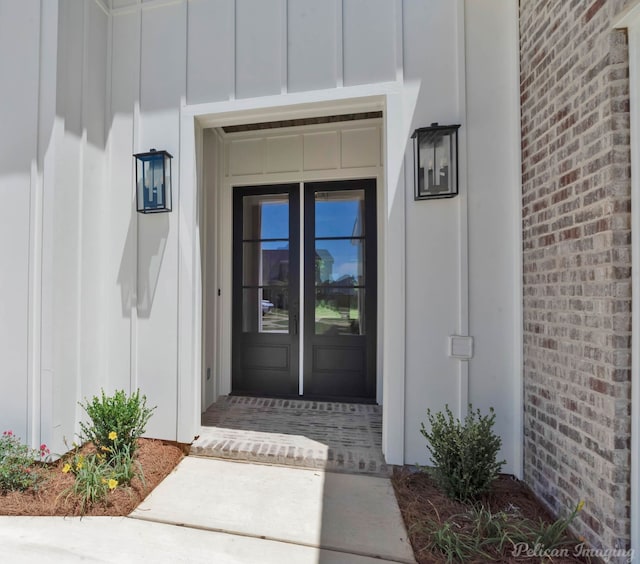 507 Cocodrie Dr, Bossier City, LA 71112 - property entrance featuring board and batten siding, brick siding, and french doors