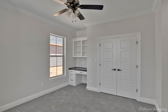 507 Cocodrie Dr, Bossier City, LA 71112 - unfurnished bedroom with crown molding, carpet, a closet, baseboards, and ceiling fan