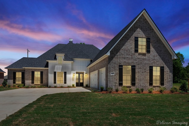 507 Cocodrie Dr, Bossier City, LA 71112 - view of front of home with concrete driveway, brick siding, a front yard, and board and batten siding