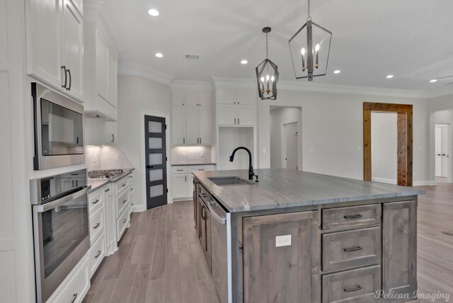 507 Cocodrie Dr, Bossier City, LA 71112 - kitchen featuring appliances with stainless steel finishes, a sink, crown molding, white cabinets, and recessed lighting