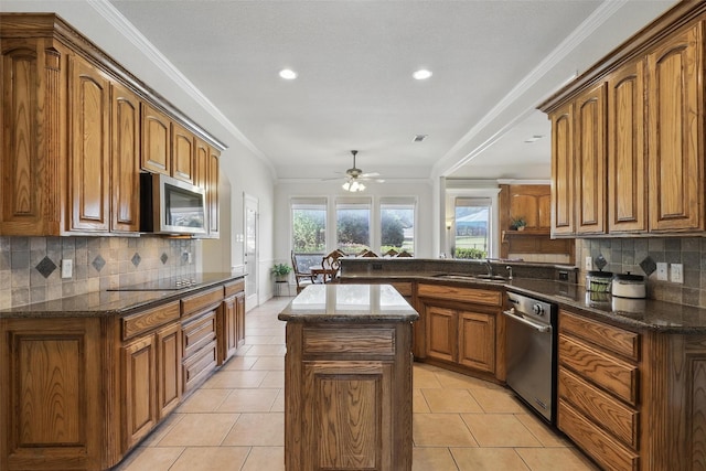 104 E Hidden Meadow Ct, Cresson, TX 76035 - kitchen featuring stainless steel appliances, a sink, ceiling fan, a kitchen island, and brown cabinetry