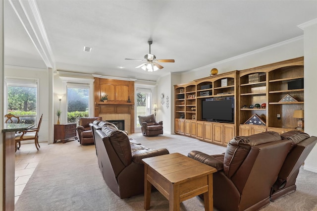 104 E Hidden Meadow Ct, Cresson, TX 76035 - living room with plenty of natural light, crown molding, a ceiling fan, a tiled fireplace, and baseboards