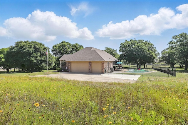 104 E Hidden Meadow Ct, Cresson, TX 76035 - view of side of home with an attached garage, driveway, brick siding, and a patio