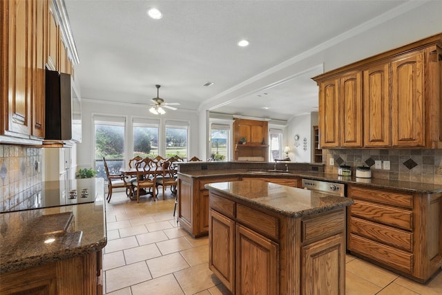 104 E Hidden Meadow Ct, Cresson, TX 76035 - kitchen featuring a peninsula, stainless steel microwave, brown cabinets, decorative backsplash, and recessed lighting