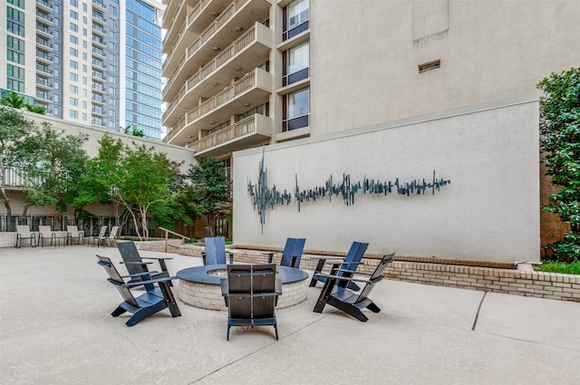 6211 W NW Hwy Unit 1504, Dallas, TX 75225 - view of patio / terrace featuring an outdoor fire pit