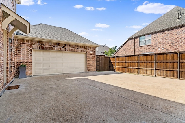 1127 Westminster Ave, Murphy, TX 75094 - view of patio featuring a garage and concrete driveway