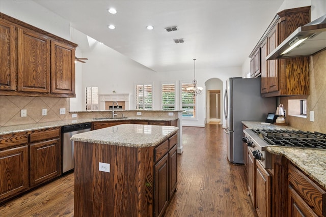 1127 Westminster Ave, Murphy, TX 75094 - kitchen featuring stainless steel appliances, wall chimney exhaust hood, a sink, a chandelier, and tasteful backsplash
