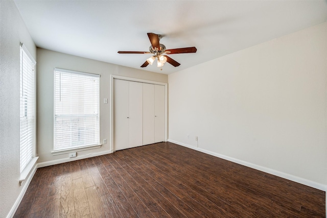 14277 Preston Rd Unit 524, Dallas, TX 75254 - unfurnished bedroom featuring dark wood-style flooring, baseboards, a closet, and a ceiling fan