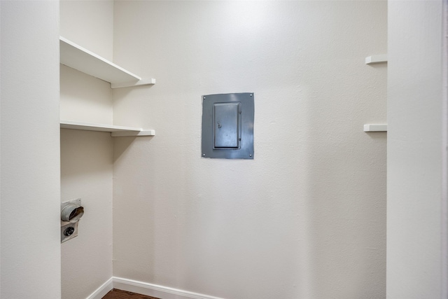 14277 Preston Rd Unit 524, Dallas, TX 75254 - laundry area featuring electric dryer hookup, electric panel, wood finished floors, and baseboards