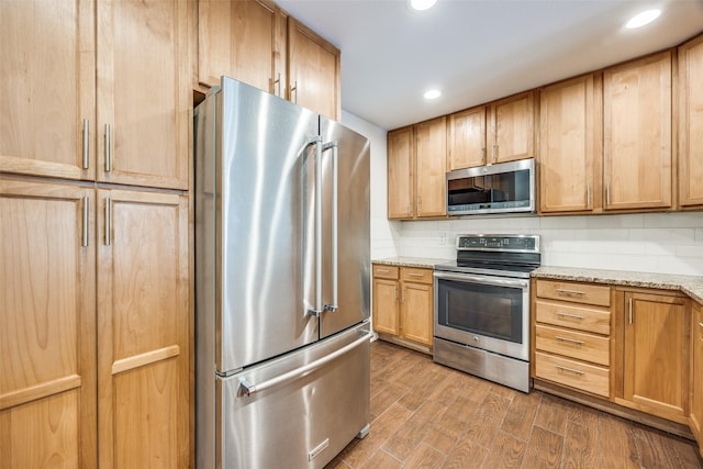 14277 Preston Rd Unit 524, Dallas, TX 75254 - kitchen with stainless steel appliances, light brown cabinets, light stone countertops, recessed lighting, and wood finished floors