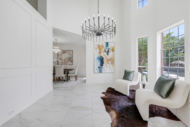 9320 Vista Cir, Irving, TX 75063 - living area with a chandelier, a high ceiling, plenty of natural light, and light marble finish flooring