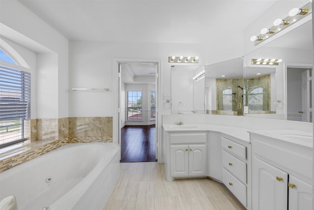 9320 Vista Cir, Irving, TX 75063 - bathroom featuring a stall shower, a tub with jets, and double vanity