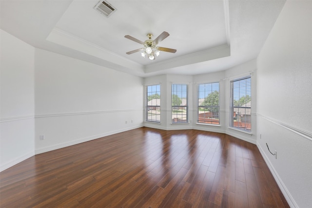 9320 Vista Cir, Irving, TX 75063 - unfurnished room with a raised ceiling, ceiling fan, ornamental molding, dark wood-style floors, and baseboards