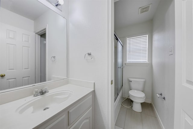 9320 Vista Cir, Irving, TX 75063 - bathroom featuring vanity, toilet, baseboards, bath / shower combo with glass door, and tile patterned floors